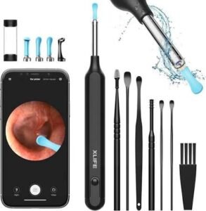 The smart ear wax removal tool laid out neatly alongside its accessories, including four colorful replacement silicone tips, a white USB-C charging cable, and an open user manual.